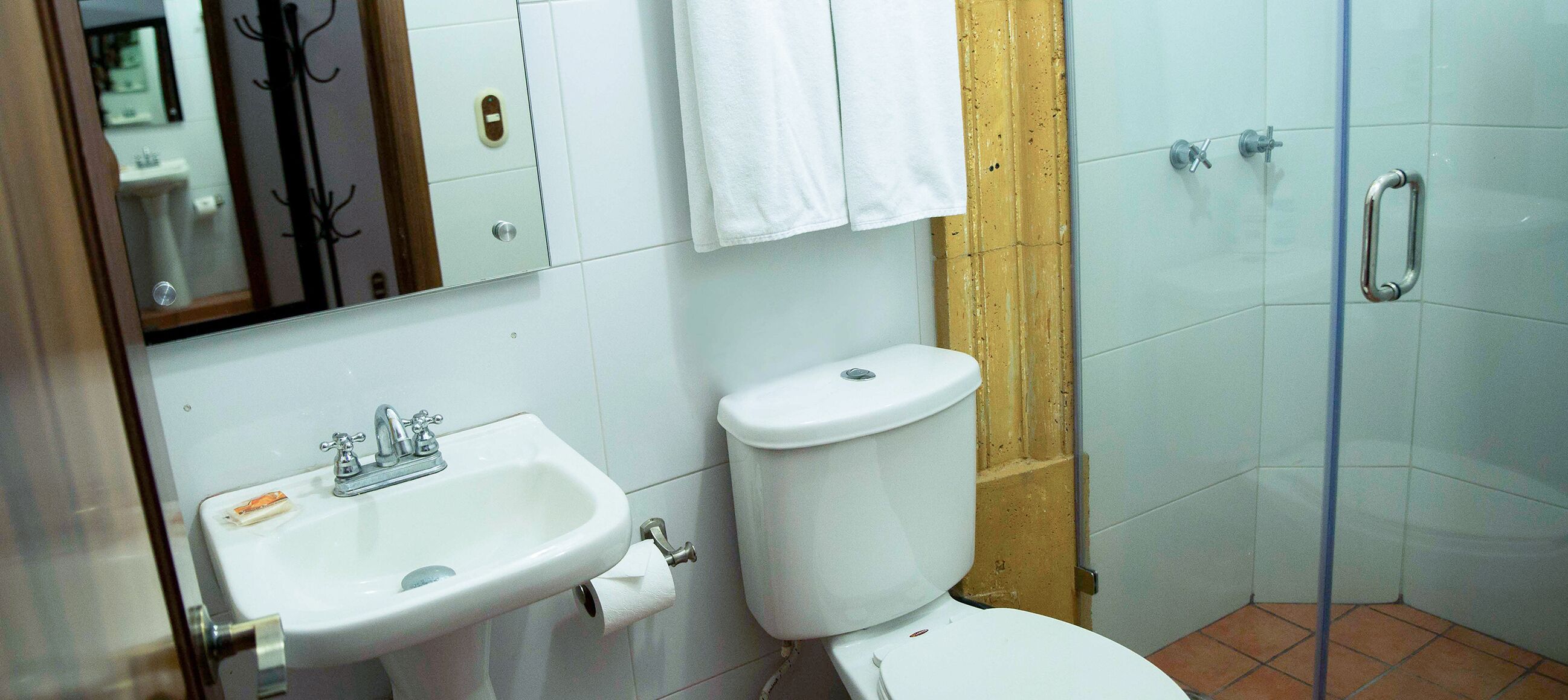 A bathroom with a sink, toilet, and shower.