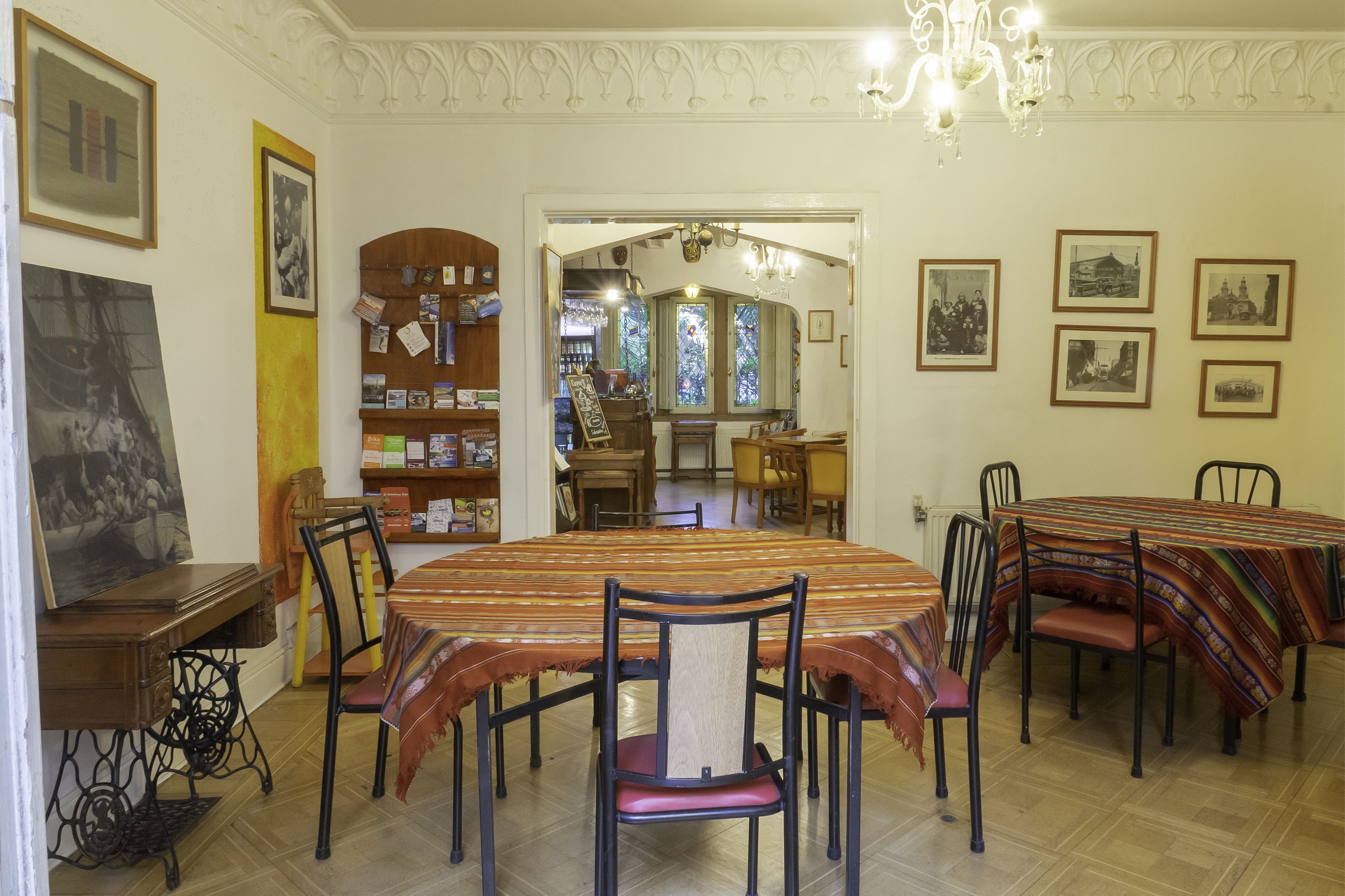 A dining area with a large table, chairs, and a bookshelf.
