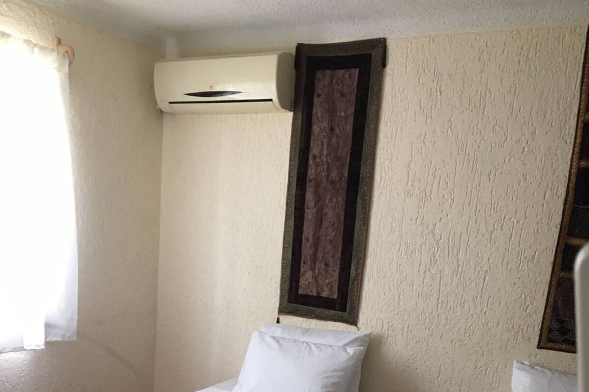 Two Individuals Beds with AC & Fan Shared Bathroom