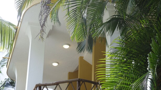 Un edificio de varios pisos con balcones y fachada blanca.