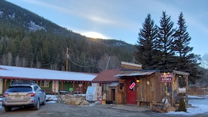 A rustic building with a red sign indicating a liquor store. - Kenosha Lodge (Grant)