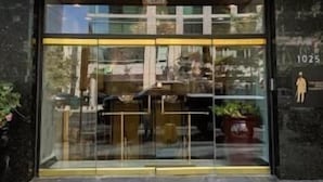 A hotel entrance with a sign reading "HOTEL" above the doors. - The Architect (Washington)