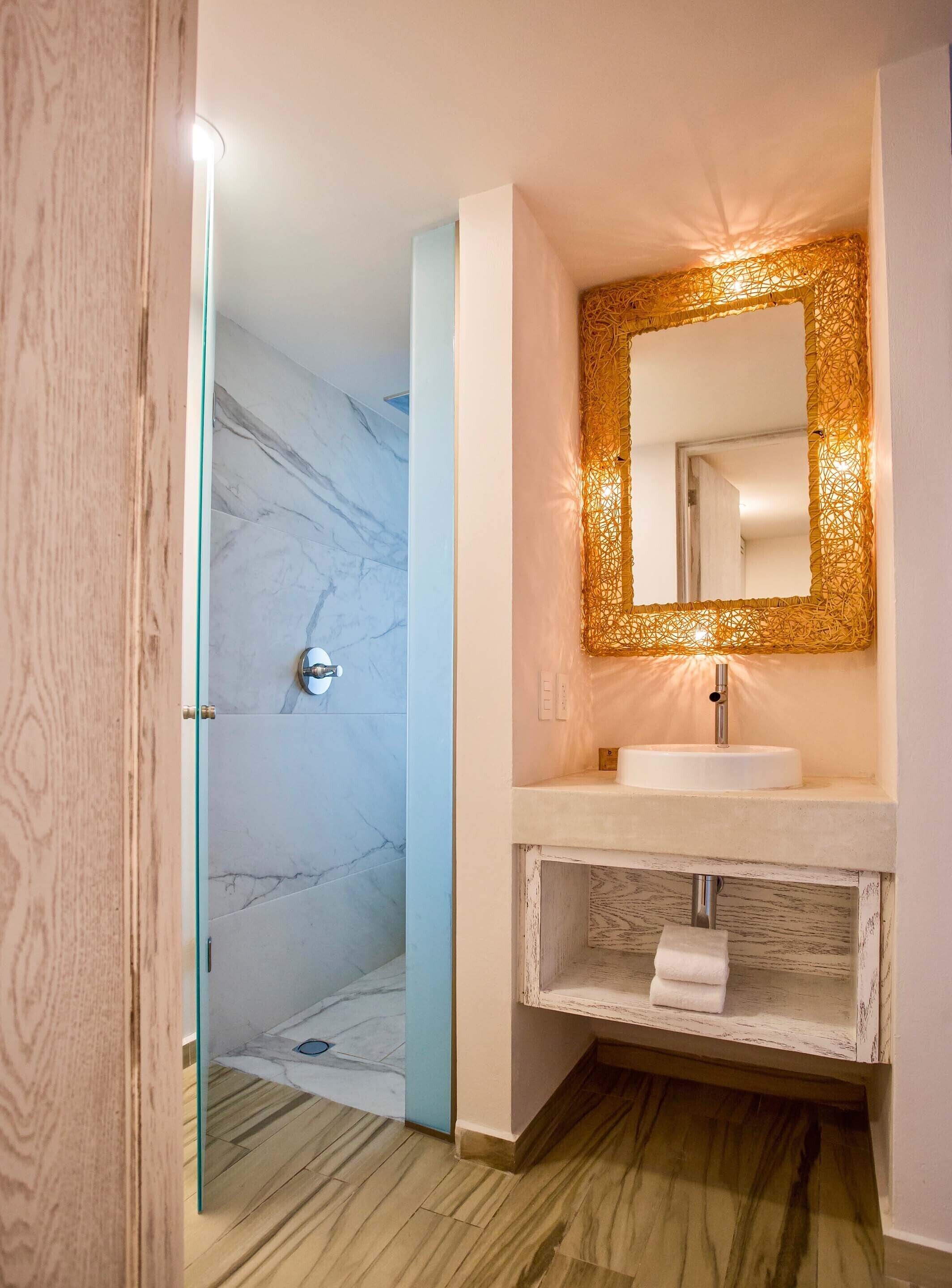 deluxe apartment | bathroom | shower, free toiletries, hair dryer, dressing gowns