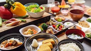 A variety of Japanese dishes including sushi, tempura, and a bowl of miso soup.