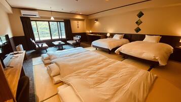 A hotel room with two beds, a desk, a chair, a TV, and a window with curtains.