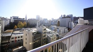 A cityscape with various buildings, including a prominent skyscraper, viewed from a high vantage point. - Shinjuku Urban Hotel (Tokyo)