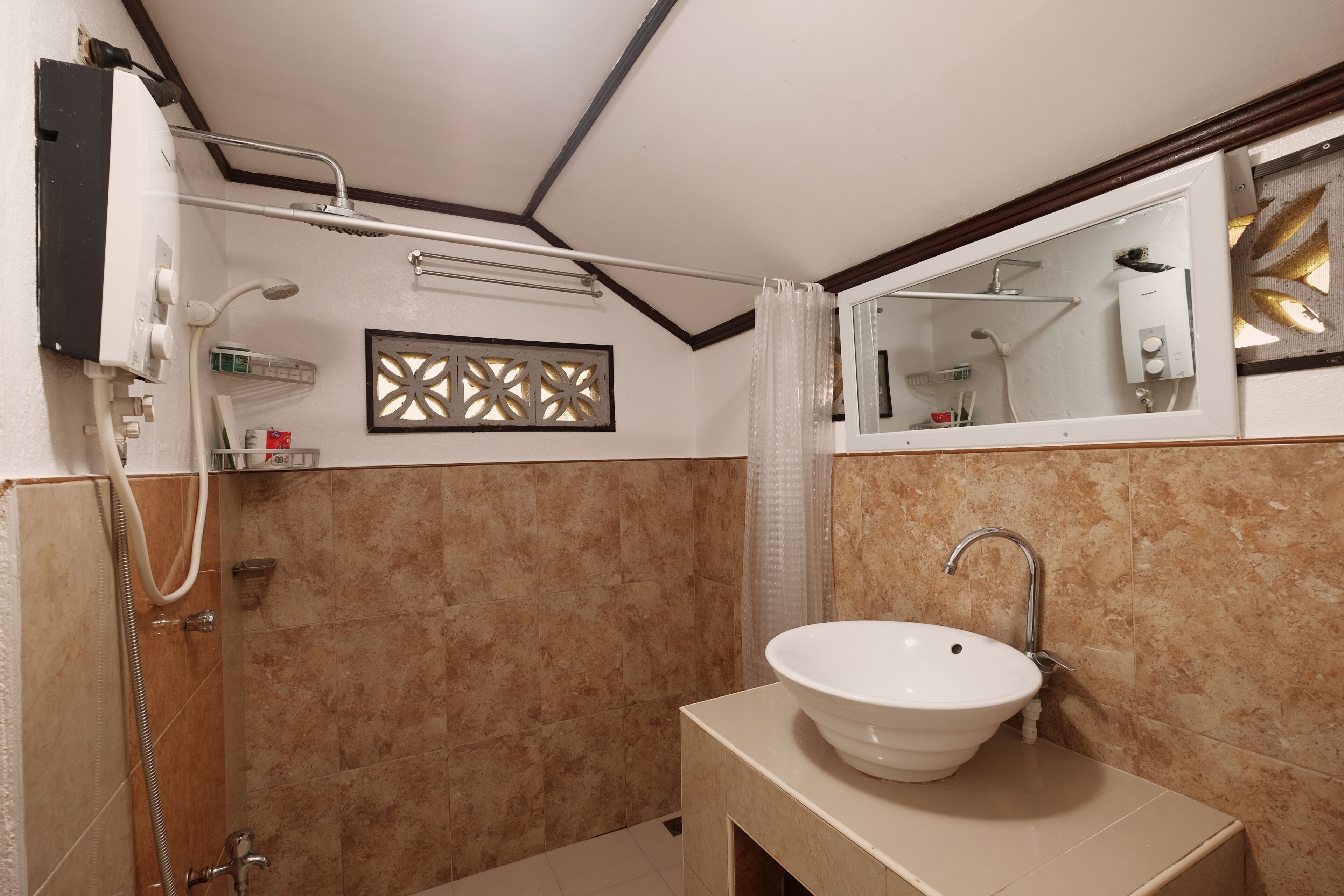 A modern bathroom with a beige sink, a shower, and a mirror with a decorative panel.