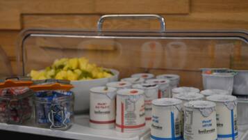A buffet setup with a variety of food items and beverages.