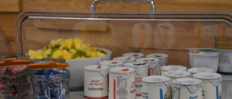 A buffet setup with a variety of food items and beverages.