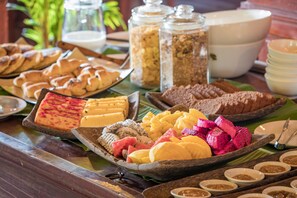 A buffet with various food items including pastries, fruits, and condiments. - Sambor Village Hotel (Stueng Saen)