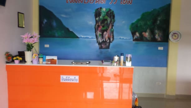 A reception desk with a blue mural depicting a mountainous landscape and a body of water. - Hotel Murano Phang-Nga Bay (Phang Nga)