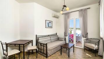 Studio Apartment with Sea View | Living area | 24-inch flat-screen TV with satellite channels, TV