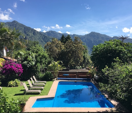 Outdoor pool, pool loungers. Hotel Casa del Angel