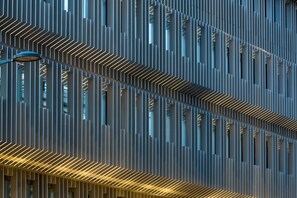 A modern building facade with vertical lines and rectangular openings. - Hotel l'Arbre Voyageur (Lille)
