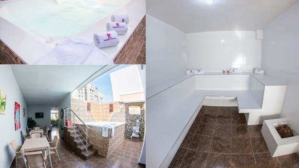 A modern hotel room with a jacuzzi, a separate bathroom, a dining area, and a staircase leading to an outdoor terrace. - Hotel Roosevelt Plaza (Cali)