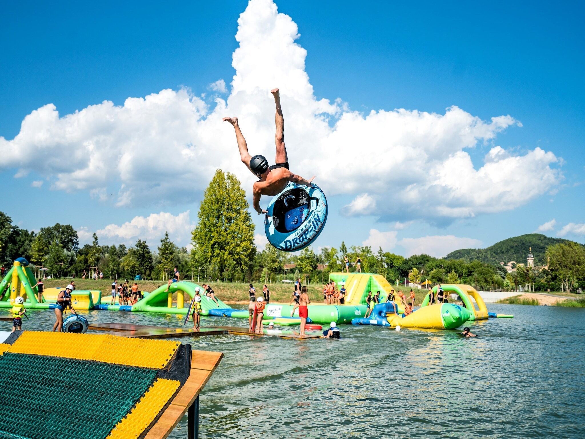 A water park with inflatable slides and a diving platform.