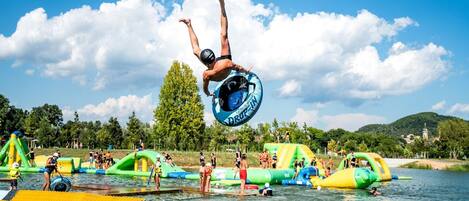 A water park with inflatable slides and a diving platform.