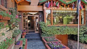 A rustic building with a wooden facade, a welcoming entrance, and a sign reading "RUSLA CHLI VILLAGE SKI". - Ruca Cheli Village Ski Hotel (San Carlos de Bariloche)
