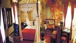 A bedroom with a four-poster bed, a nightstand, and a mirror. - Ruca Cheli Village Ski Hotel (San Carlos de Bariloche)