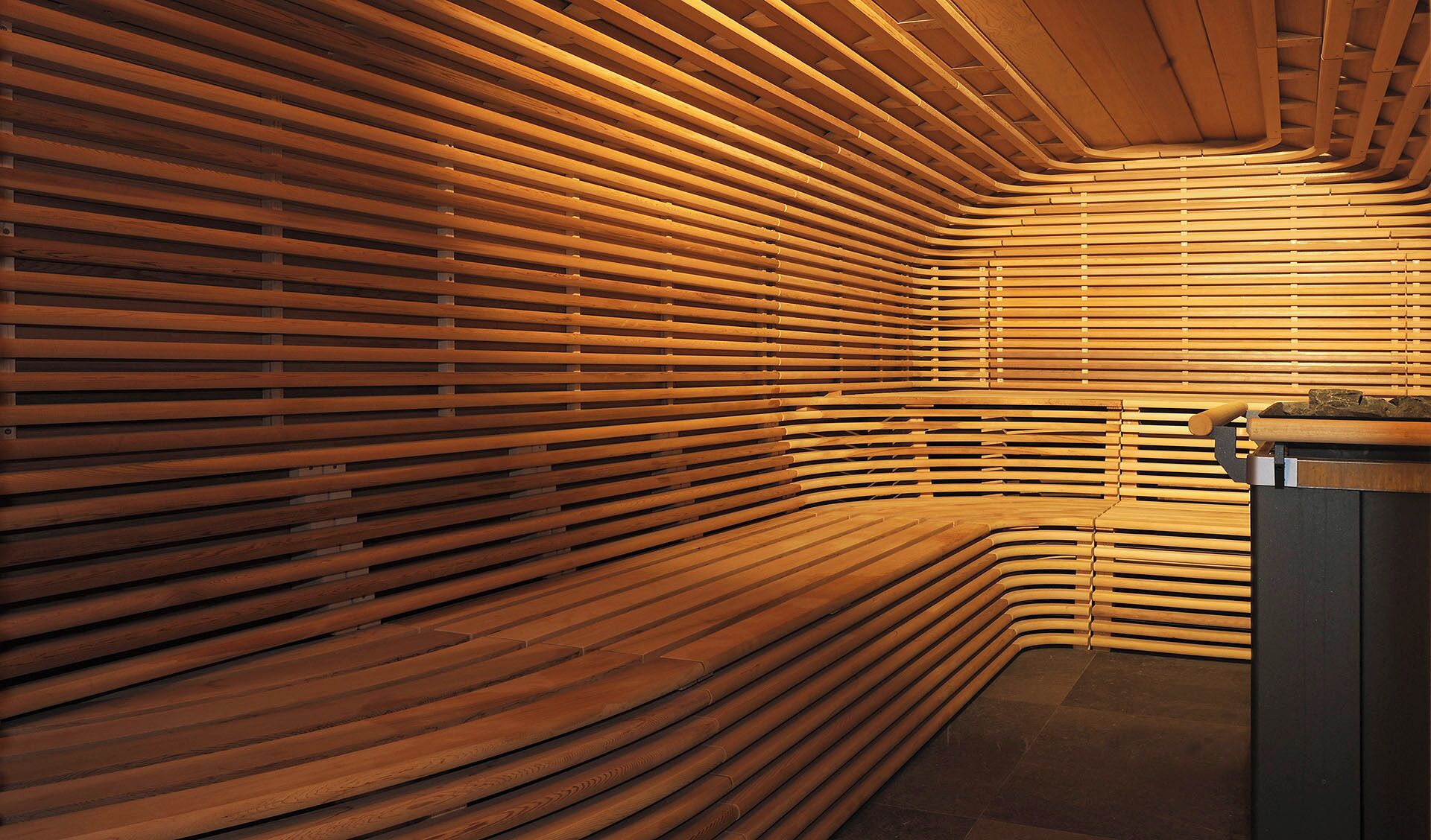 A modern interior with wooden slats forming a curved wall.