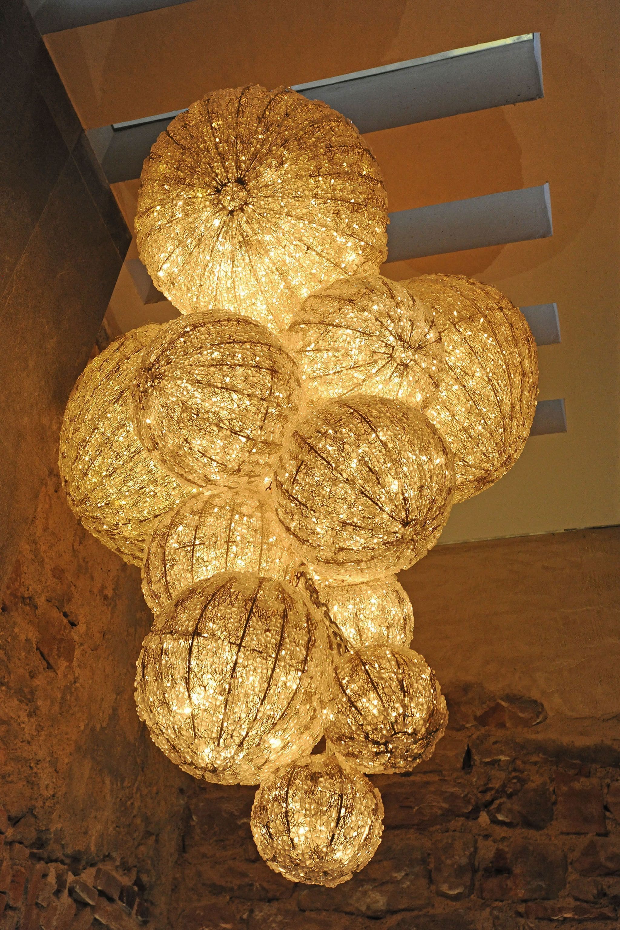 A chandelier with multiple spherical glass bulbs.