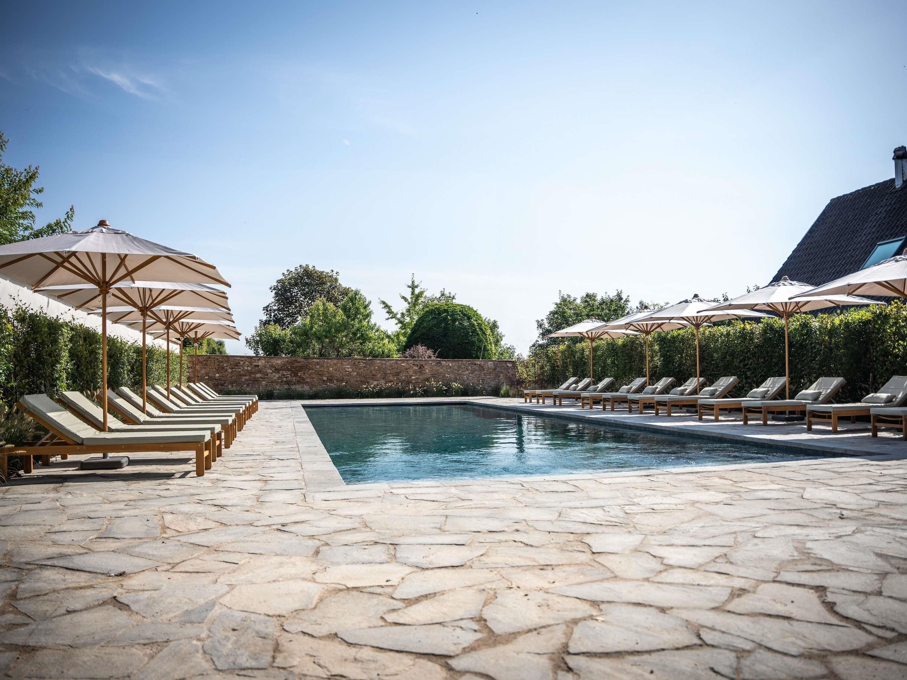 Seasonal outdoor pool, open 9:00 AM to 8:00 PM, pool umbrellas