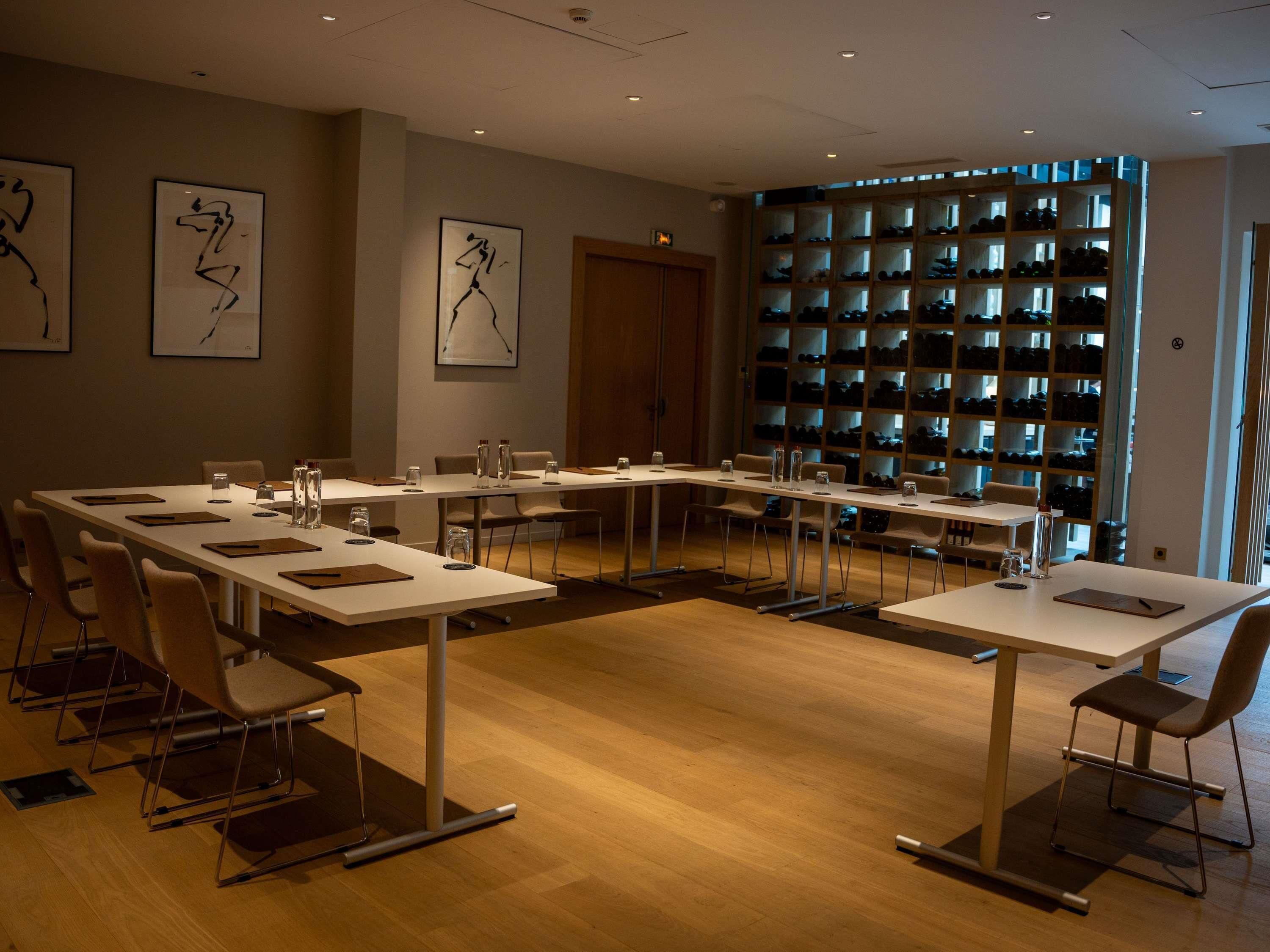 A conference room with a long table, chairs, and a shoe display.