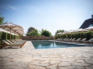 Seasonal outdoor pool, open 9:00 AM to 8:00 PM, pool umbrellas