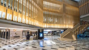 A spacious lobby with a checkered floor, a staircase, and a reception area. - bai Hotel Cebu (Mandaue)