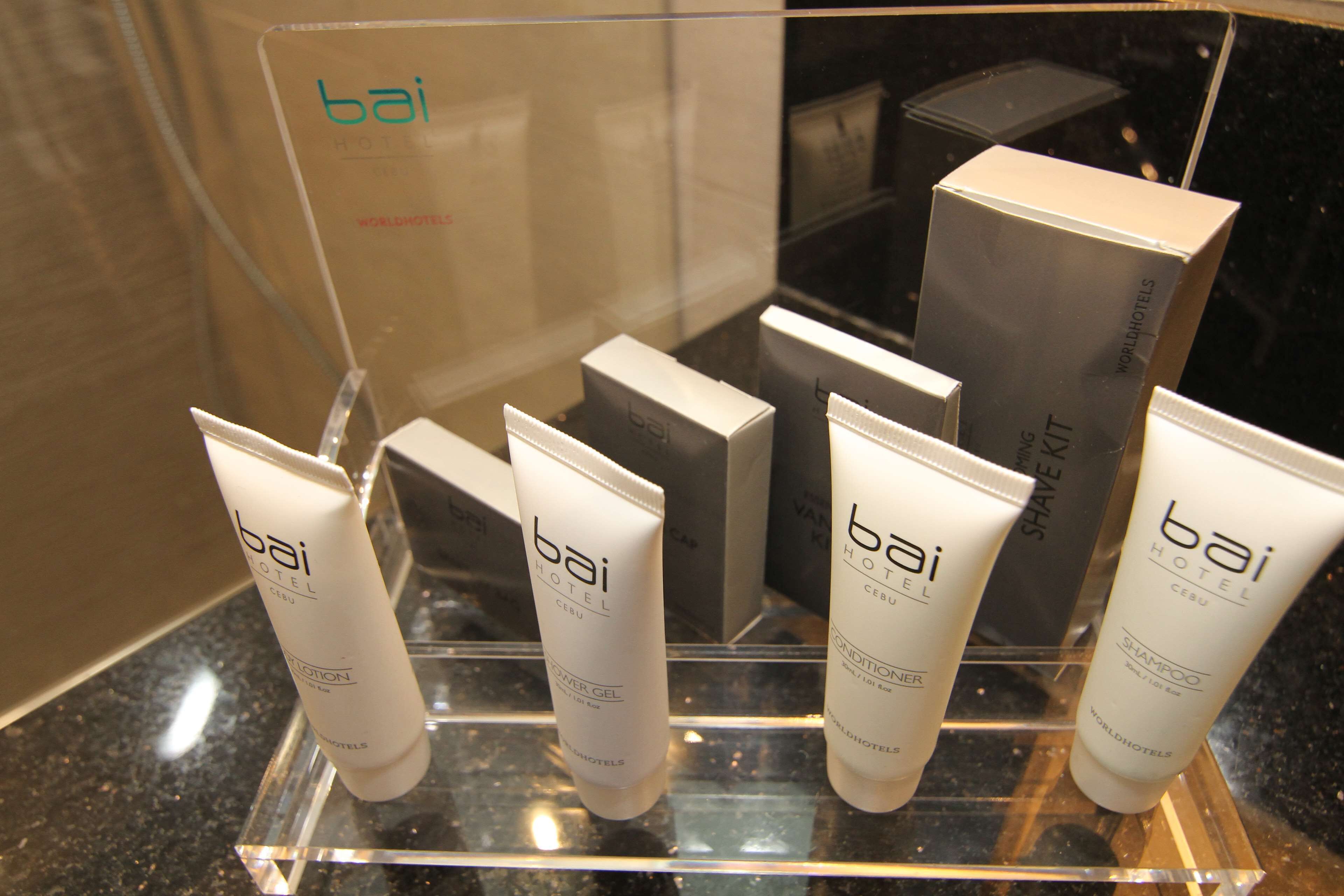 A display of bai hotel toiletries including lotion, shower gel, conditioner, and shampoo.