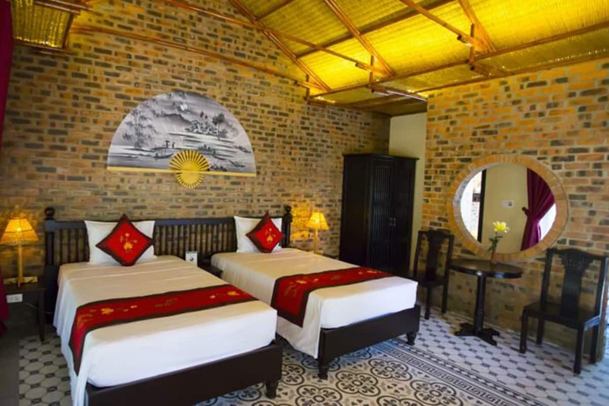 A room with two beds, a large mirror, a wall mural, and a patterned floor.