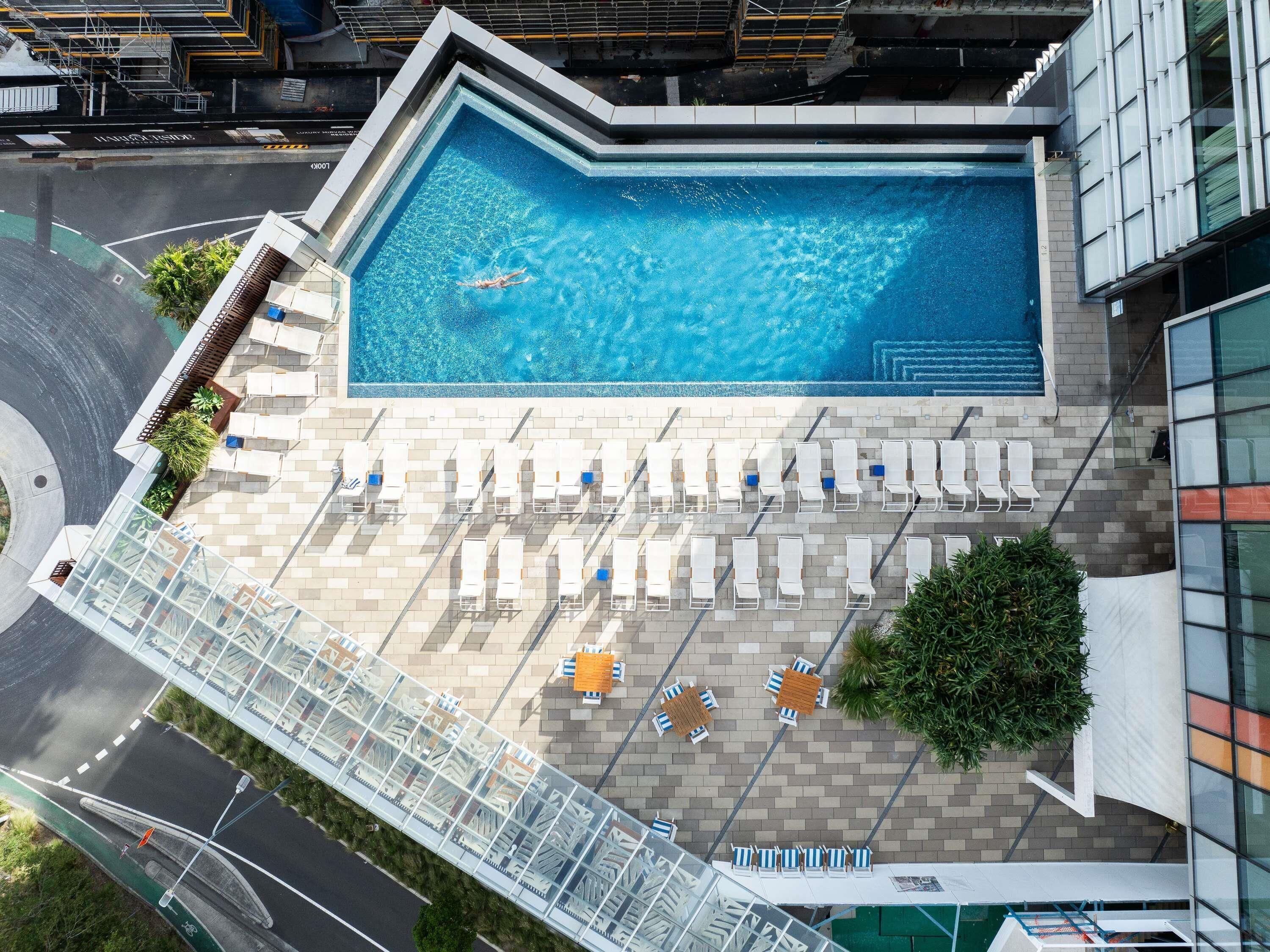 Outdoor pool, open 6 AM to 9 PM, pool loungers