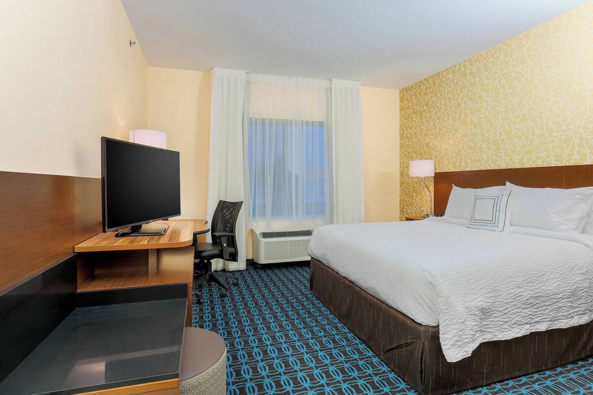 Premium bedding, desk, laptop workspace, blackout drapes