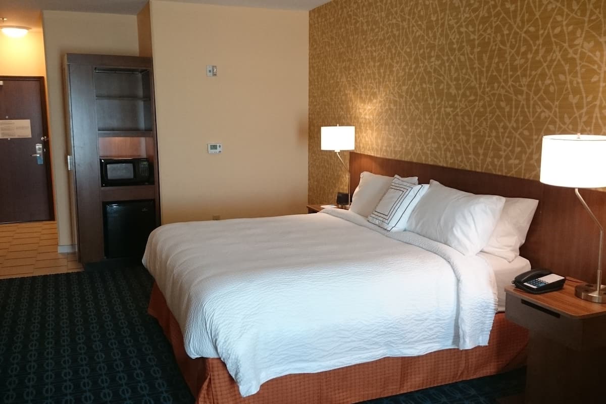 Premium bedding, desk, laptop workspace, blackout drapes