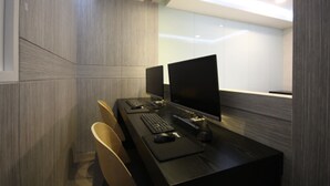 Un espace de bureau moderne comprenant un grand bureau, deux écrans, un clavier et une souris.