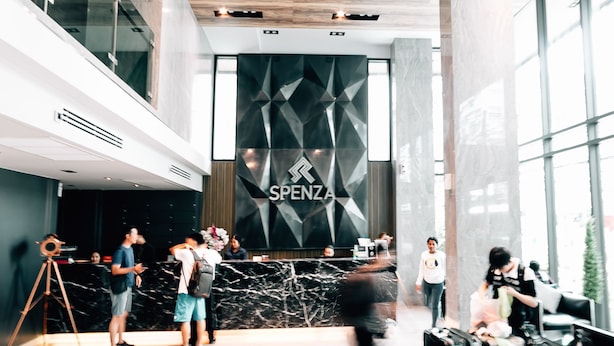 A modern hotel lobby with a reception desk, a geometric wall design, and a wooden ceiling. - Spenza Hotel (Bangkok)