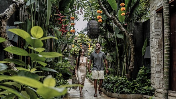A pathway flanked by lush greenery and hanging lanterns, leading to a stone building. - Aksari Villa Seminyak by Ini Vie Hospitality (Seminyak)