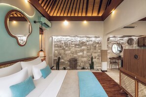 A bedroom with a bed, a mirror, a stone wall, and a wooden ceiling. - Aksari Villa Seminyak by Ini Vie Hospitality (Seminyak)