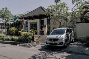 A silver car parked in front of a building with a stone facade and a tiled roof. - Aksari Villa Seminyak by Ini Vie Hospitality (Seminyak)