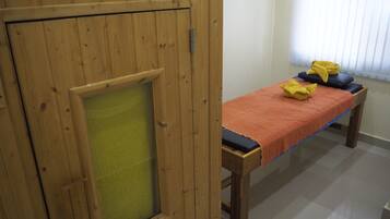 Features a wooden cabinet with a frosted glass window, a bench, and a tiled floor.
