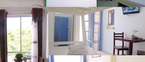Habitación de hotel con cama, escritorio, silla, televisor y ventana.