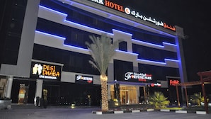 A multi-story building with signage for Fortune Park Hotel, Desi Dhaba, and other establishments. - Fortune Park Hotel (Dubai)