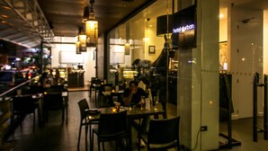 An indoor dining area with tables and chairs, a ceiling fan, and a sign that reads "hotel durban". - Hotel Durban (Makati)