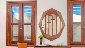 A room with a wooden desk, a chair, a bed, and a window with a view. - Casa Sabbionara (Chania)