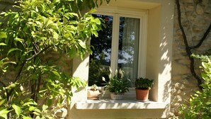 A stone building with a window sill holding potted plants. - Holiday Home in Provence with Pool & Tennis (Piolenc)