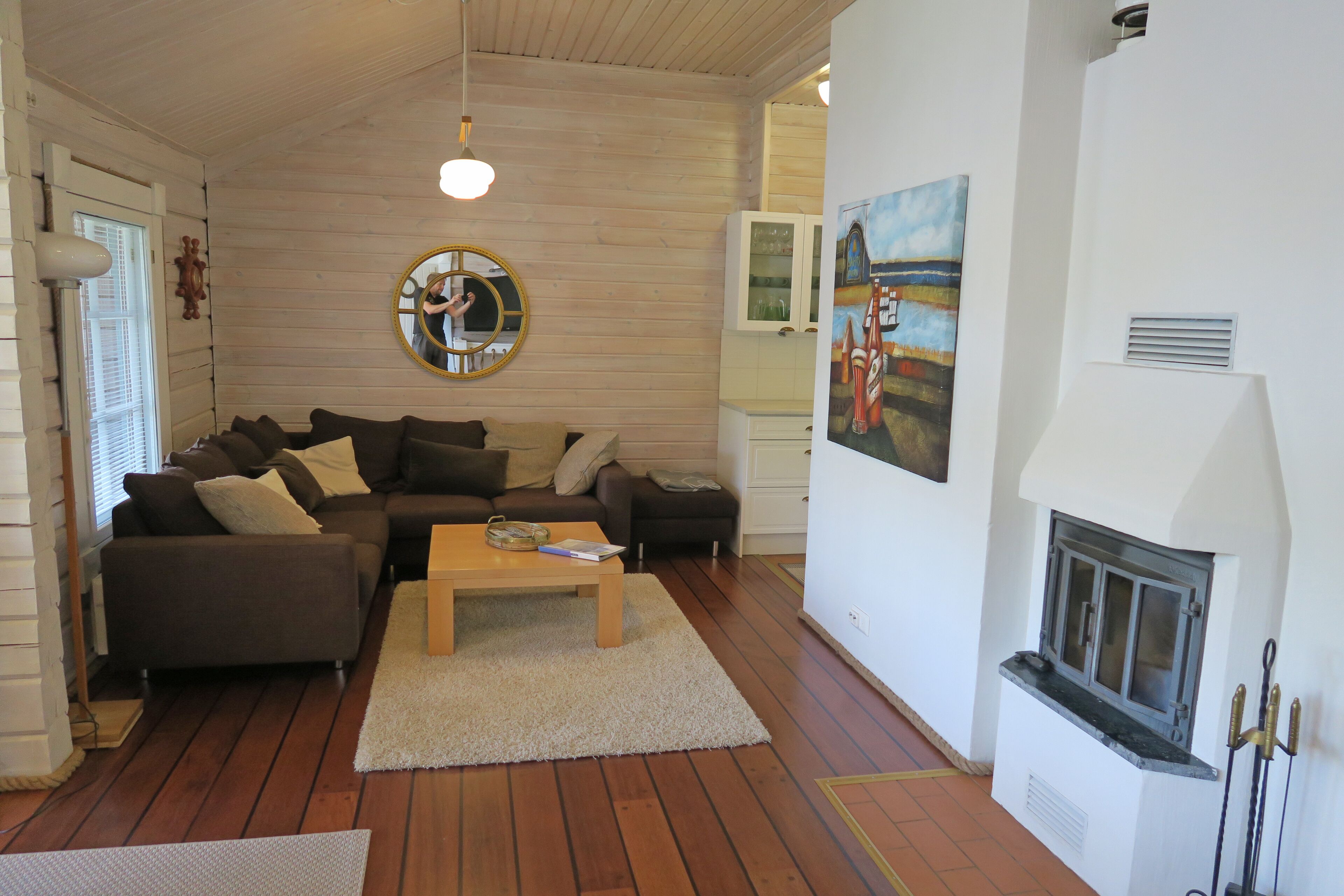 A cozy living room with a sectional sofa, a coffee table, and a fireplace.