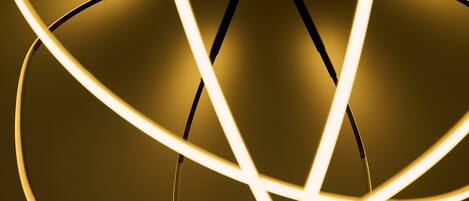 A close-up of a modern chandelier with multiple light fixtures.