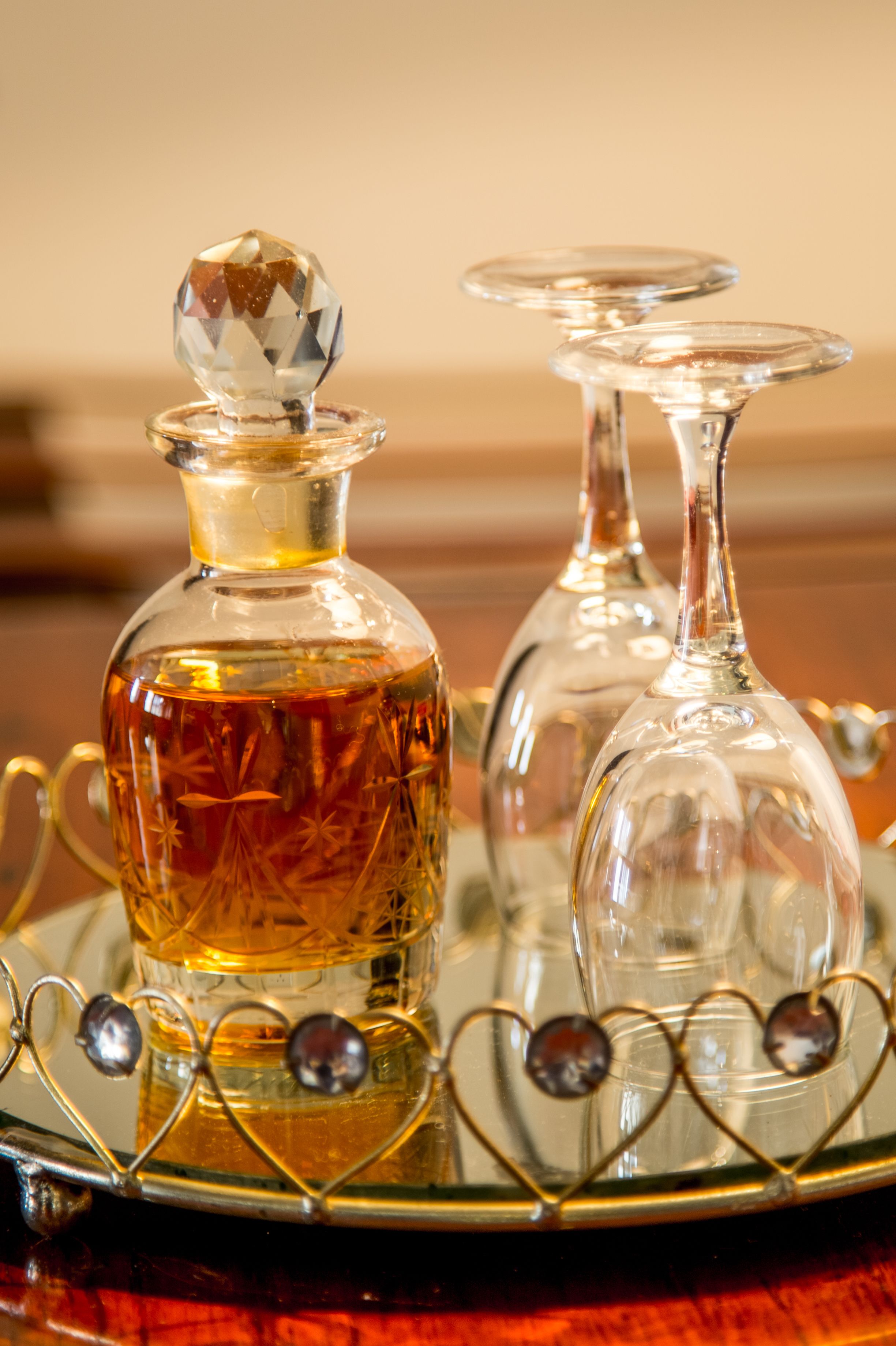 Two glass decanters on a tray with heart-shaped decorations.