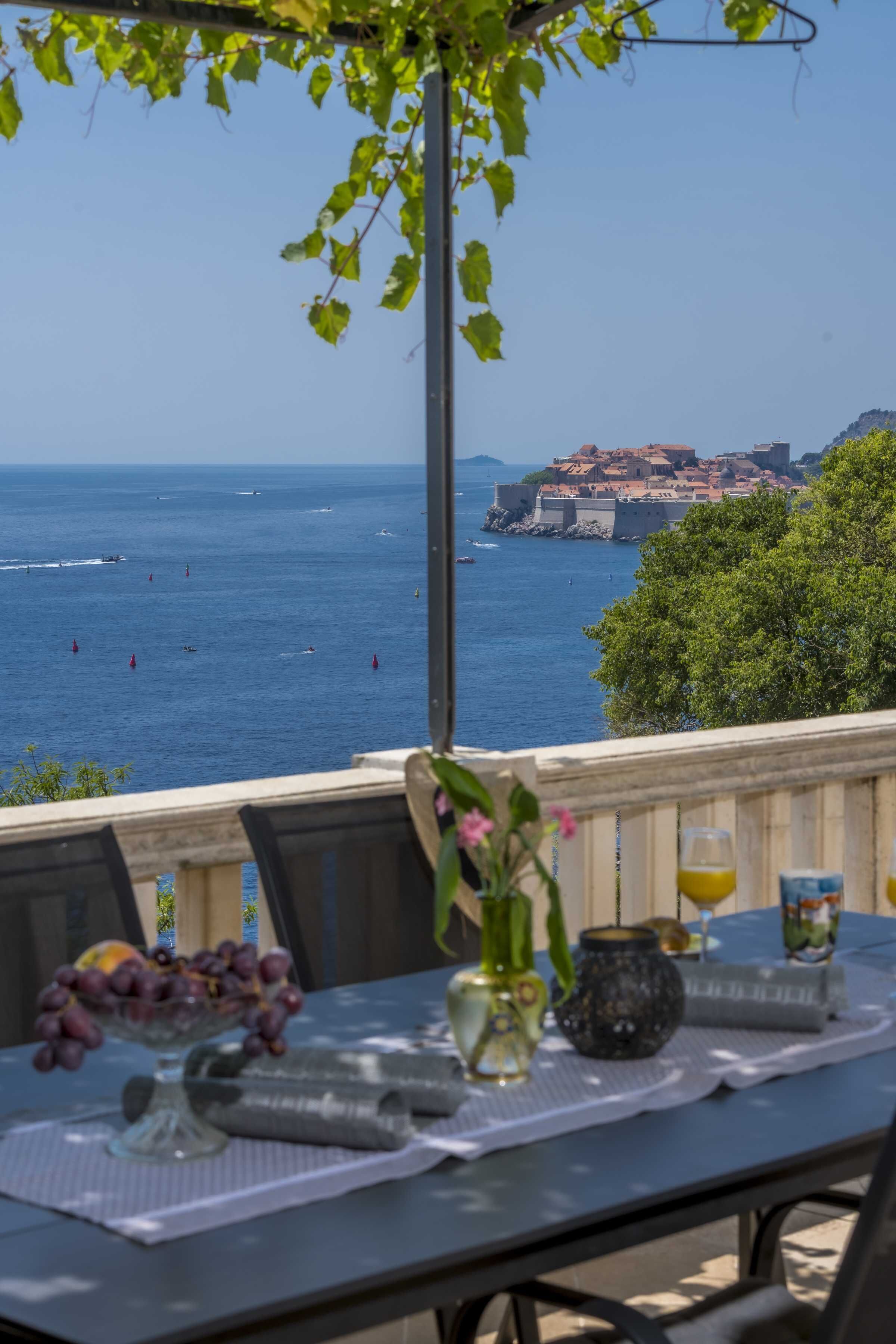 A table with a view of the sea and a historic building.