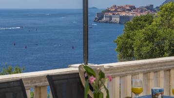 A table with a view of the sea and a historic building.